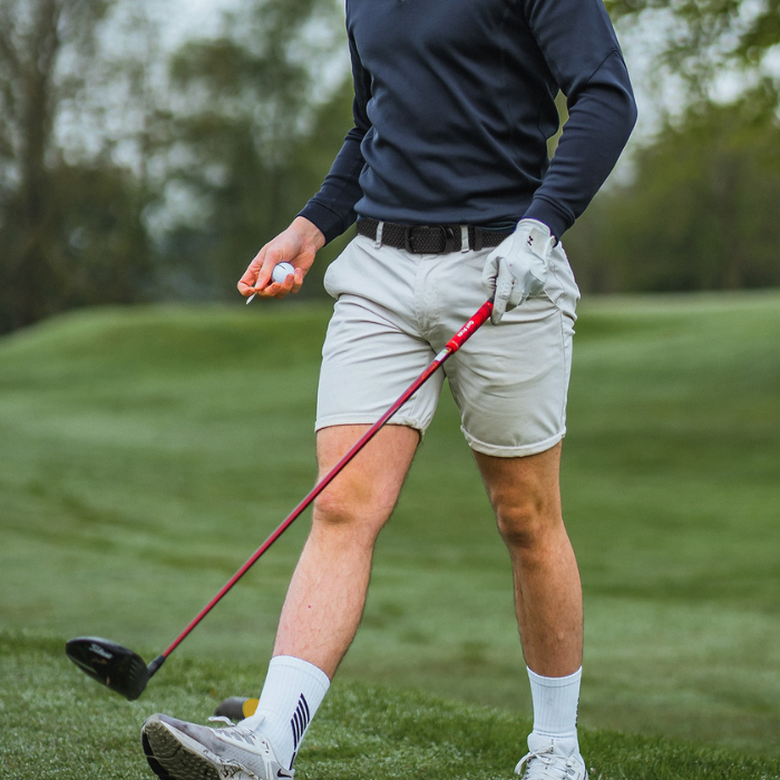 Mens stretch belt in use with casual golf outfit